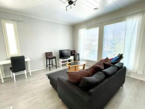 a living room with a couch and a table at Apartment Isorannantie in Pyhäjoki