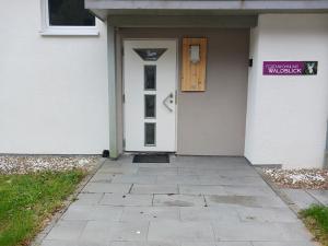 a front door of a house with a purple sign on it at Ferienwohnung Waldblick in Freudenstadt