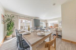 a dining room with a long table and chairs at Cherry Garth HOT TUB HIRE AVAILABLE in Keswick