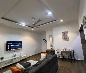 a living room with a couch and a table at Cozy Haven Suite in Accra