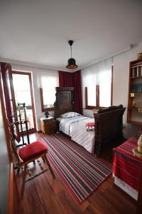 a bedroom with a bed and a desk and a chair at Hostel-F in Gjakove