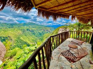 a balcony with chairs and a view of the mountains at San Augustin - Standard Double Room - Colombia in San Agustín