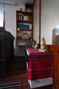 a room with a table with a red table cloth at Hostel-F in Gjakove