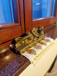 a gold statue sitting on a counter next to a window at Hostel-F in Gjakove