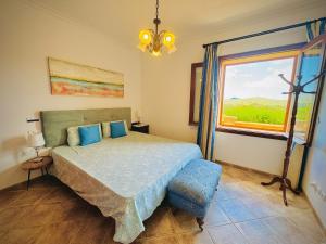 a bedroom with a large bed and a window at Finca Son Manxo (villas2meet Mallorca) in Manacor +22 photos