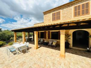 a patio with a table and chairs and a building at Finca Son Manxo (villas2meet Mallorca) in Manacor