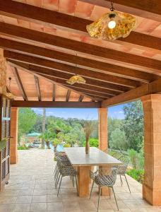 a patio with a table and chairs and a ceiling at Finca Son Manxo (villas2meet Mallorca) in Manacor