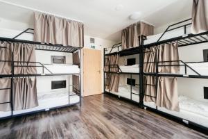 a room with four bunk beds in a dorm at Hostel Mandarinka in Prague
