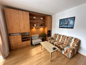 a living room with a couch and a table at Vila Dům Evropa in Třeboň