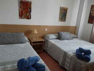 Postel nebo postele na pokoji v ubytování Apartamentos la Escuela en Cantabria