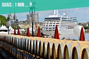 a cruise ship is docked in a harbor with umbrellas at Spacious 2-Bedroom Family Duplex with Free Parking and Netflix in Bordeaux