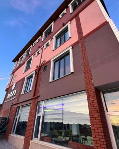 un edificio de ladrillo rojo con reflejo del océano en Ahlat 1071 Otel&Restaurant en Erkizan