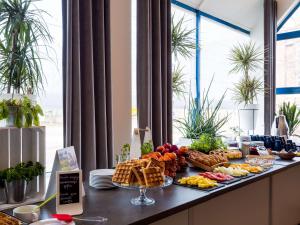 a buffet of food on top of a table at Mercure Czestochowa Centrum in Częstochowa