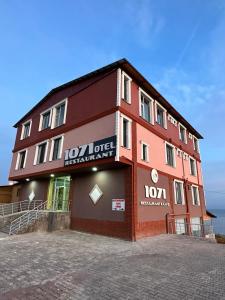 a building with a sign on the side of it at Ahlat 1071 Otel&Restaurant in Erkizan