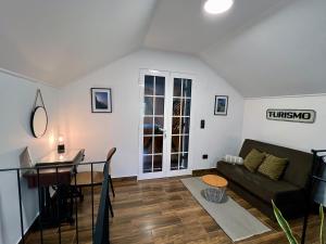 a living room with a couch and a table at Traditional House in Curral das Freiras +17 photos