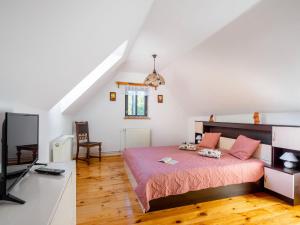 a bedroom with a bed and a flat screen tv at Holiday Home Horní Prysk by Interhome in Liberec