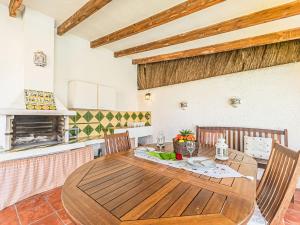 a dining room with a wooden table and chairs at Holiday Home Santiago - RDB100 by Interhome in Roda de Bará