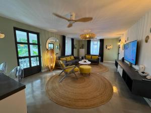 a living room with a couch and a table at Beautiful beach apartment in Flic-en-Flac