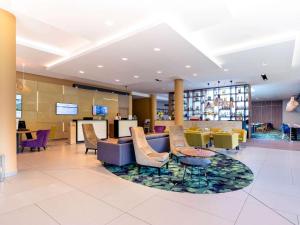 eine Lobby eines Hotels mit Stühlen und Tischen in der Unterkunft Mercure Jelenia Góra in Jelenia Góra