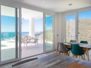 a dining room with a table and a view of the ocean at Apartment Bayview Hills by Interhome in Torrox Costa