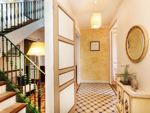 a hallway with a staircase and a mirror at Apartment Baldri by Interhome in Tossa de Mar +18 photos