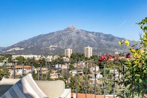 a mountain in the background of a city at Molo Luxury Suites Puerto Banus in Marbella