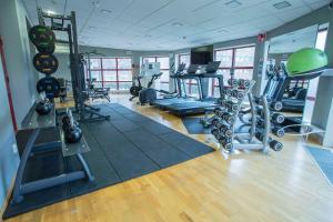 a gym with treadmills and machines in a room at Scandic Star Lund in Lund