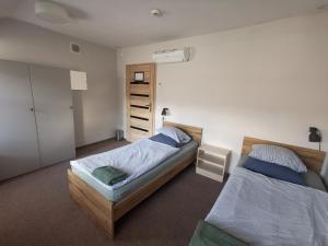 a bedroom with two beds and a closet at Bemma Apart Hostel in Wrocław