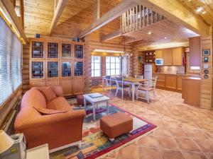 a living room and kitchen in a log cabin at Holiday Home Estrella levi by Interhome in Levi