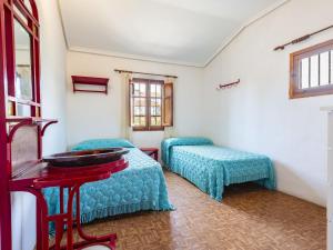 a room with two beds and a table and windows at Holiday Home D'estiu by Interhome in El Grao