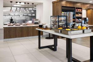 a kitchen with a table with food on it at Hilton Garden Inn Milford in Milford