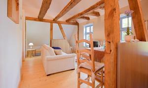 a living room with a chair and a refrigerator at Haus zu den Büschen 04 in Wustrow