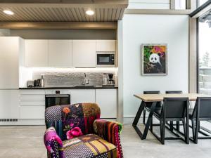 a kitchen and dining room with a table and chairs at Holiday Home Naava chalet 103 by Interhome in Ähtäri