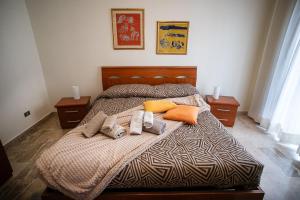 a bedroom with a bed with two towels and pillows at Monte camicia - cozy home city center in LʼAquila