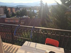 a view of a balcony with a table and a chair at Monte camicia - cozy home city center in LʼAquila