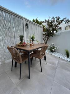 a wooden table and chairs on a patio at Aleria Central Apartment 2 in Naxos Chora