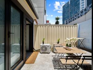 a patio with a table and chairs on a balcony at 3 Bdrms Sydney CBD & Central station & Chinatown in Sydney