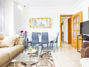 een woonkamer met een bank en een tafel bij Apartment Vistamar II - Marina d'Or by Interhome in Oropesa del Mar