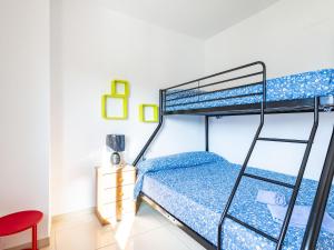 een slaapkamer met een stapelbed en een rode stoel bij Apartment Vistamar II - Marina d'Or by Interhome in Oropesa del Mar