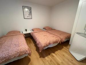 um quarto com duas camas e uma foto na parede em 300meter walk to LEGO house - 70m2 apartment with garden em Billund