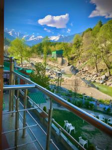 a balcony with a view of a river and mountains at The Avenue River Side Hotel - Near Volvo Bus Stand Manali in Manāli +19 photos
