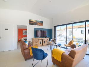 a living room with couches and chairs and a tv at Villa Charme de la Blancharderie by Interhome in Barbâtre +32 photos