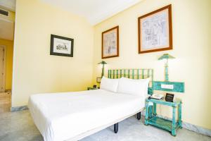 Postel nebo postele na pokoji v ubytování AZZ Mérida Medea Hotel