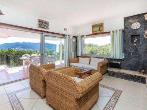 a living room with two couches and a fireplace at Holiday Home Tortuga by Interhome in Llança +28 photos