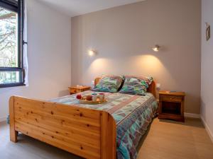 a bedroom with a bed with a wooden bed frame at Apartment Le Bellevue by Interhome in Saint-Brevin-les-Pins