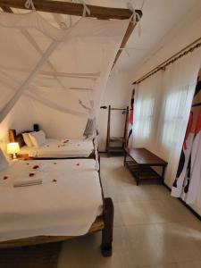 Ein Bett oder Betten in einem Zimmer der Unterkunft Babalao Bungalows