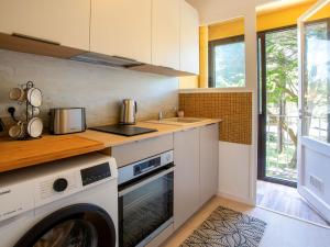 a kitchen with a washer and dryer in a room at Apartment Le Bellevue by Interhome in Saint-Brevin-les-Pins