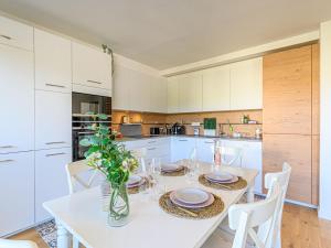 a kitchen with a white table and white cabinets at Apartment Ty Breiz by Interhome in La Trinité-sur-Mer