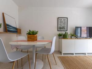 a dining room with a table and white chairs at Apartment Aries by Interhome in Cambrils