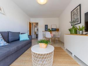 a living room with a couch and a table at Apartment Aries by Interhome in Cambrils +23 photos